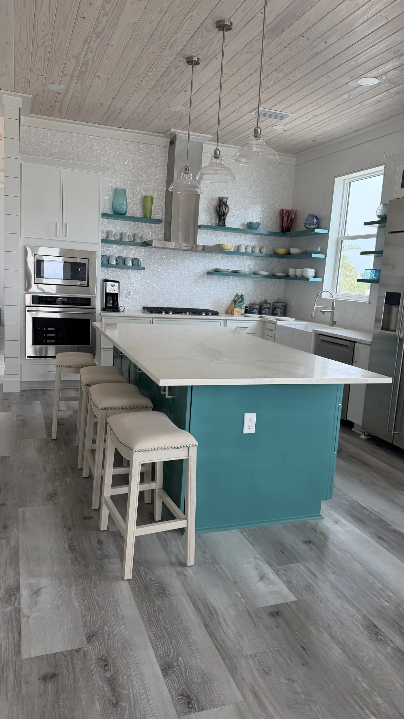 Kitchen with a blue island and shelving