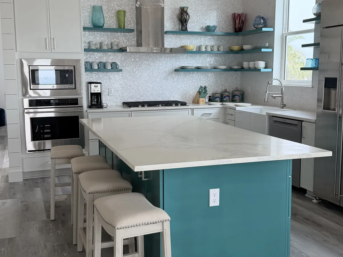 Kitchen with a blue island and open shelving