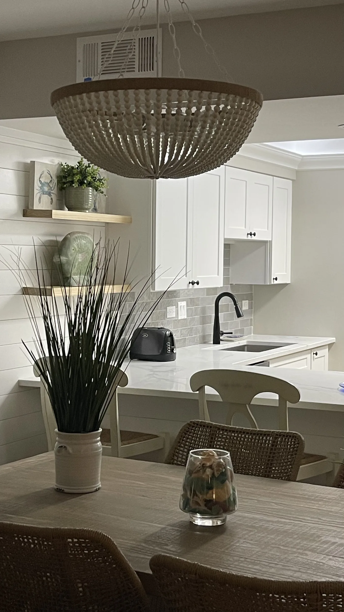 Kitchen with an island and a chandelier